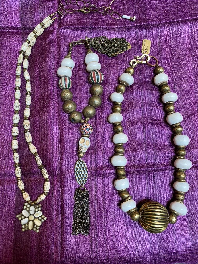 Unique medley of African bovine beads, brass, and hand rolled ceramic Java beads with carved ivory resin skull named Boo. Only at serrahna.com